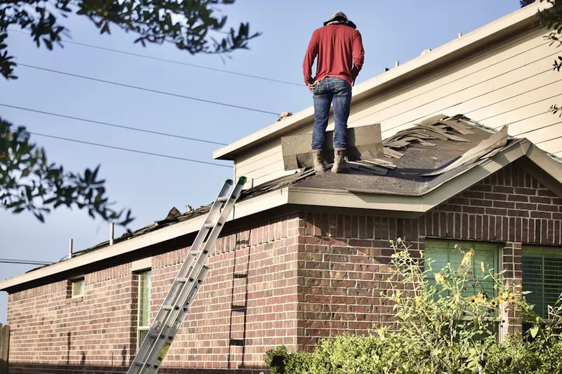 Professional roofer working on a residential roof in Fossilville